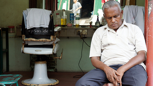 Hairdresser sleeps in chair.